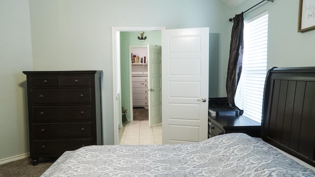 bedroom with baseboards and vaulted ceiling