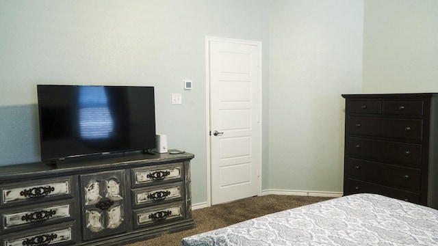 bedroom featuring carpet floors and baseboards