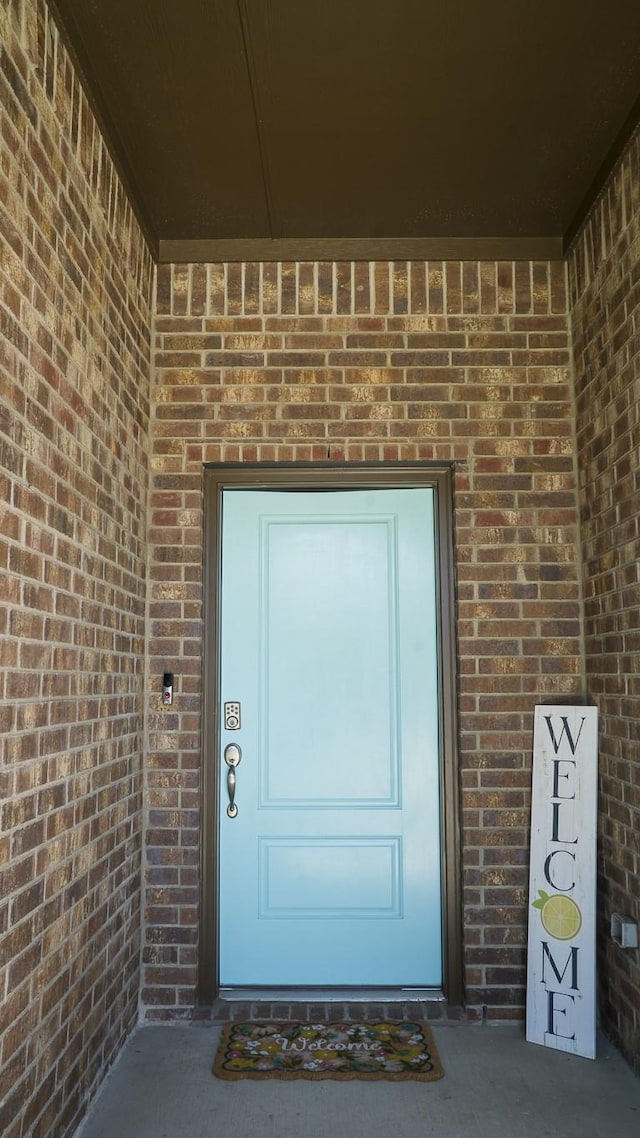 property entrance with brick siding