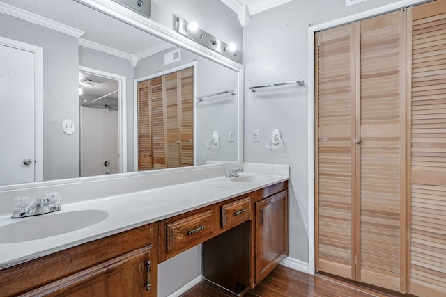 full bathroom featuring a sink, double vanity, wood finished floors, and visible vents