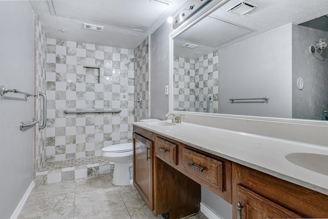 full bathroom featuring visible vents, a sink, toilet, and a shower stall