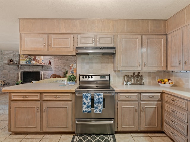 12580 Briar Rd, Azle, TX 76020 - kitchen featuring under cabinet range hood, stainless steel range with electric stovetop, light tile patterned floors, light countertops, and a textured ceiling