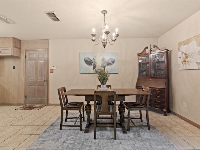 12580 Briar Rd, Azle, TX 76020 - dining room with a chandelier, light tile patterned floors, baseboards, and a textured ceiling