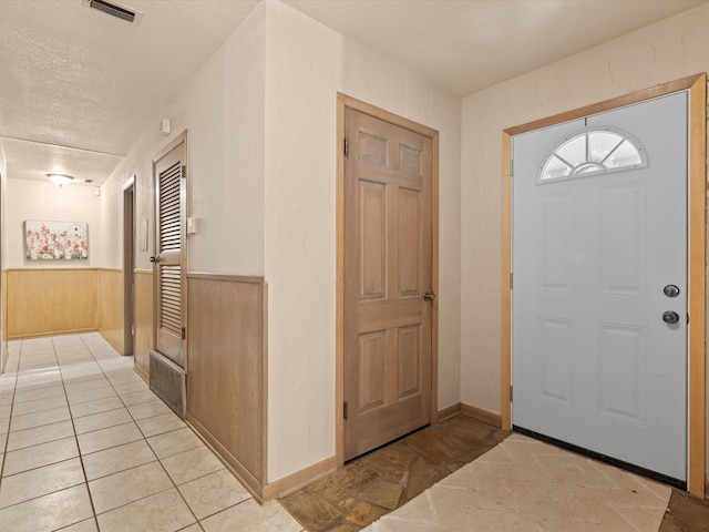 12580 Briar Rd, Azle, TX 76020 - foyer with a textured ceiling, a wainscoted wall, and wood walls
