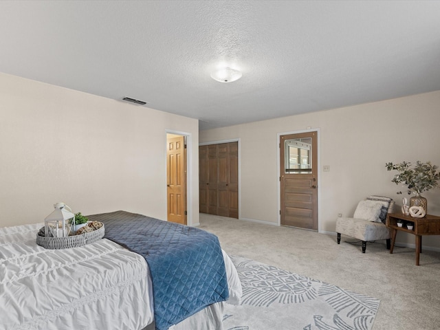 12580 Briar Rd, Azle, TX 76020 - bedroom with light carpet, a textured ceiling, baseboards, and a closet