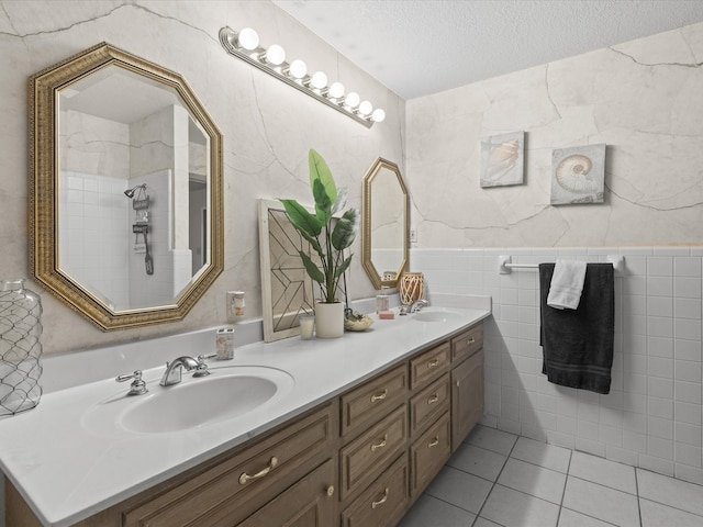 12580 Briar Rd, Azle, TX 76020 - bathroom with double vanity, tile walls, tile patterned flooring, and a textured ceiling