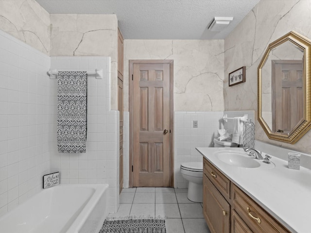 12580 Briar Rd, Azle, TX 76020 - full bath featuring tile walls, vanity, tile patterned flooring, a textured ceiling, and toilet