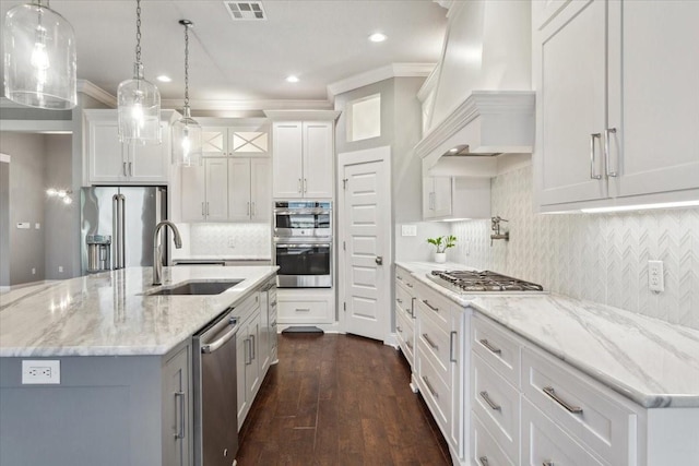kitchen with visible vents, crown molding, a sink, custom exhaust hood, and stainless steel appliances