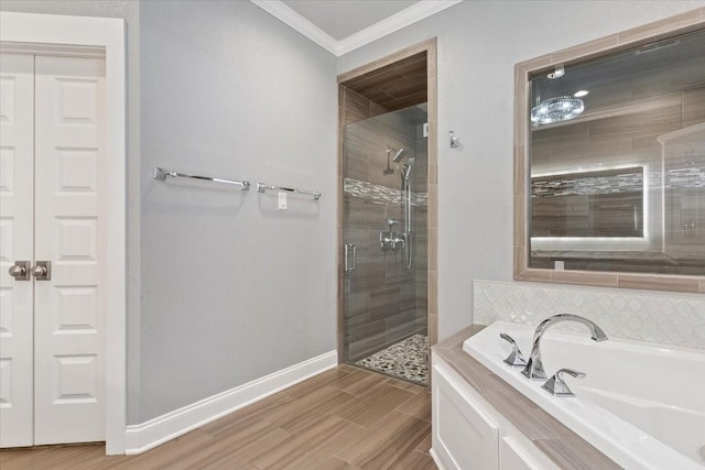bathroom featuring a garden tub, crown molding, a stall shower, wood finished floors, and baseboards