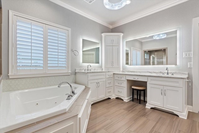 bathroom with crown molding, a whirlpool tub, and vanity