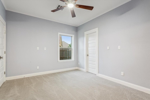 empty room with crown molding, ceiling fan, and light carpet