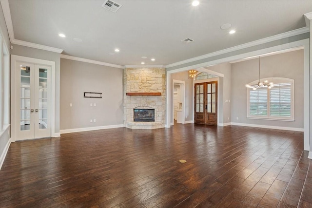 unfurnished living room featuring french doors, dark wood-style flooring, visible vents, a notable chandelier, and ornamental molding