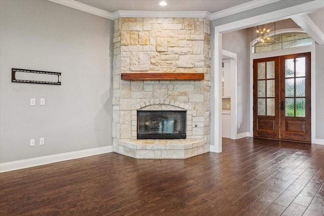 unfurnished living room with ornamental molding, wood finished floors, baseboards, a chandelier, and french doors