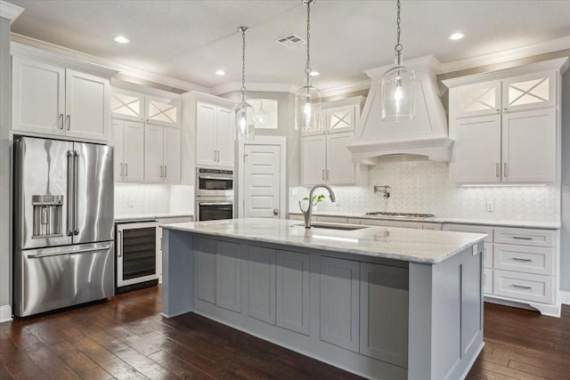 kitchen featuring a sink, beverage cooler, dark wood finished floors, stainless steel appliances, and custom exhaust hood