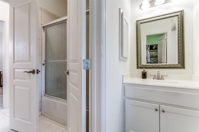 full bathroom with enclosed tub / shower combo, tile patterned flooring, and vanity