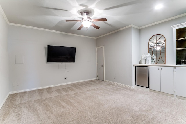 unfurnished living room with a ceiling fan, light carpet, and ornamental molding