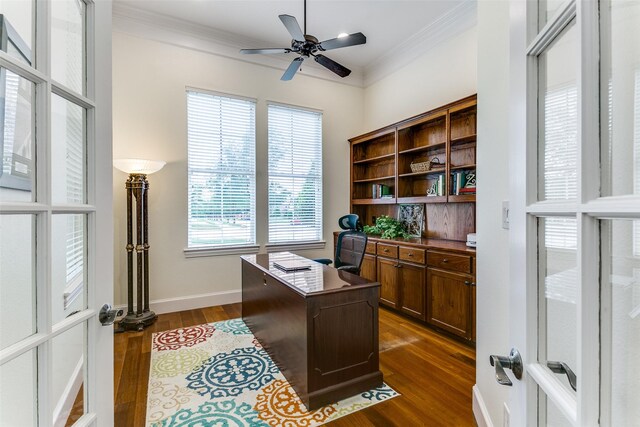 office featuring baseboards, ornamental molding, dark wood-style flooring, and a ceiling fan