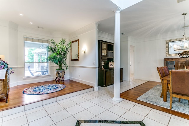 interior space featuring visible vents, ornamental molding, decorative columns, and light tile patterned floors
