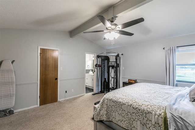 carpeted bedroom with ensuite bathroom, lofted ceiling with beams, and ceiling fan