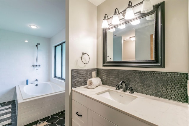 full bath featuring tile walls, tile patterned flooring, a shower, vanity, and tiled bath