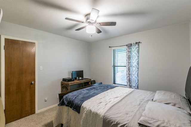 bedroom featuring carpet floors, baseboards, and ceiling fan