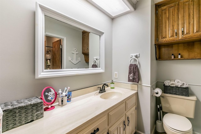 bathroom with toilet and vanity