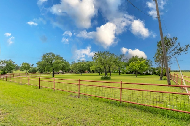 view of yard with a rural view and fence
