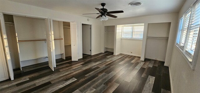 6404 Brentwood Dr, Fort Worth, TX 76112 - unfurnished bedroom featuring visible vents, multiple closets, dark wood-style floors, and multiple windows
