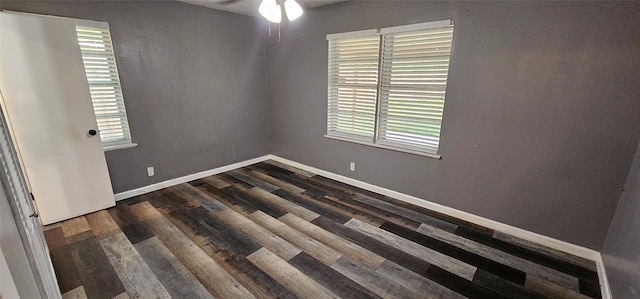 6404 Brentwood Dr, Fort Worth, TX 76112 - unfurnished room with plenty of natural light, dark wood-style flooring, ceiling fan, and baseboards
