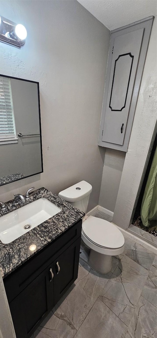 6404 Brentwood Dr, Fort Worth, TX 76112 - bathroom featuring toilet, marble finish floor, and vanity