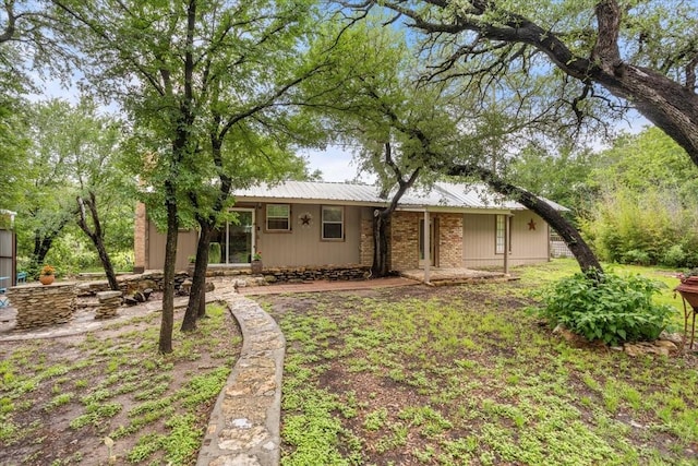 rear view of property with metal roof