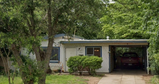 bungalow-style home with driveway and an attached carport