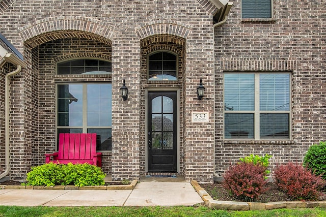 property entrance with brick siding