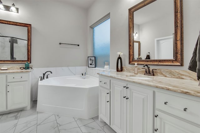 bathroom featuring vanity, marble finish floor, a bath, and a shower stall