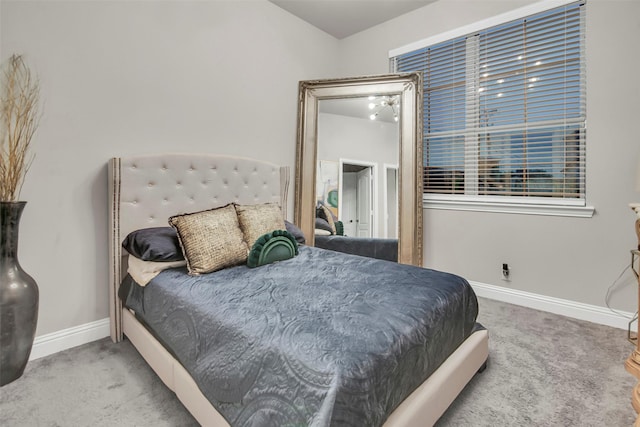 bedroom with baseboards and carpet flooring