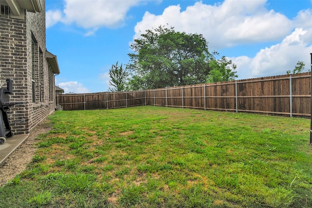 view of yard with a fenced backyard