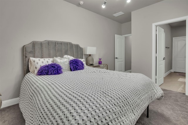 bedroom featuring visible vents, carpet flooring, and baseboards