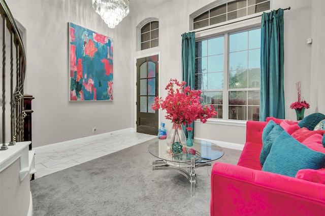 interior space with baseboards, a chandelier, and marble finish floor
