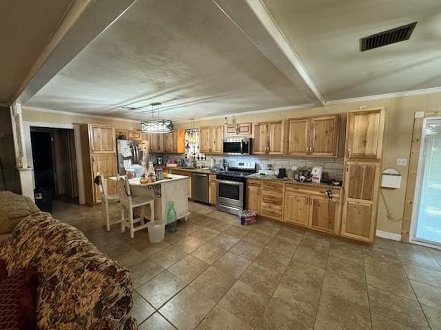 405 E Lee St, Rotan, TX 79546 - kitchen featuring decorative light fixtures, visible vents, tasteful backsplash, a breakfast bar, and stainless steel appliances