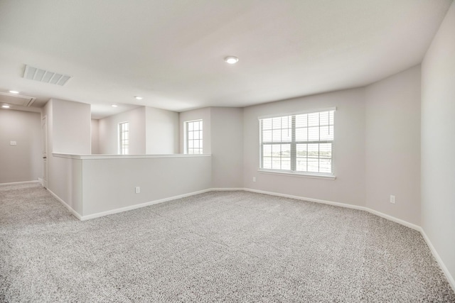 empty room featuring visible vents, carpet flooring, baseboards, and recessed lighting
