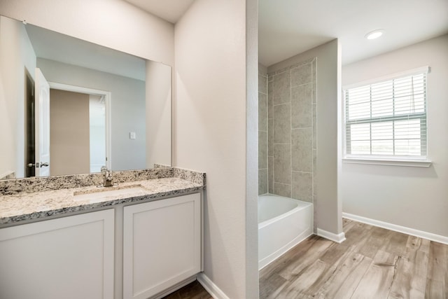 full bathroom featuring vanity, baseboards, shower / bathing tub combination, and wood finished floors