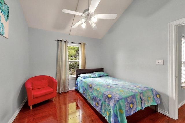 bedroom with lofted ceiling, wood finished floors, baseboards, and ceiling fan