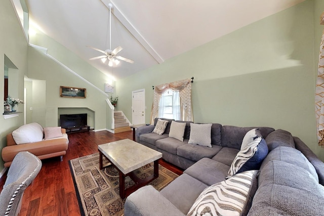living area with a ceiling fan, stairway, dark wood-type flooring, beamed ceiling, and high vaulted ceiling