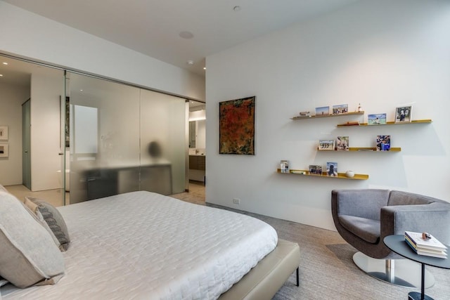 bedroom with recessed lighting, light carpet, and a closet