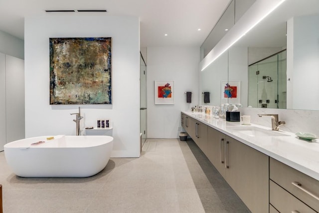 bathroom featuring double vanity, a sink, a stall shower, and a soaking tub