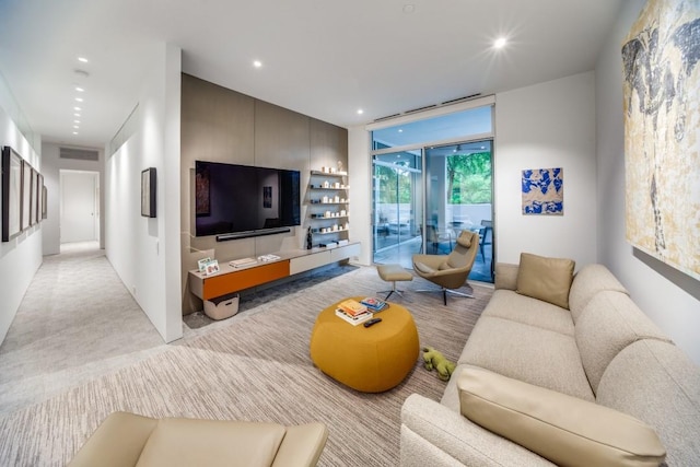 living area featuring recessed lighting, visible vents, and expansive windows