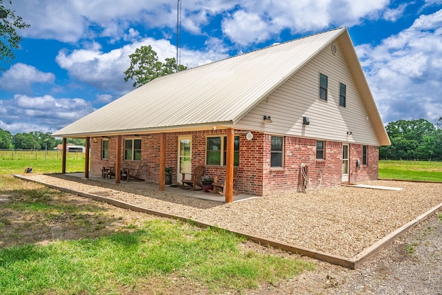 397 Rs County Road 4452, Point, TX 75472 - view of property exterior featuring a patio area, metal roof, and brick siding