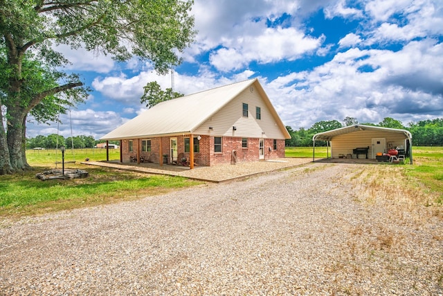 397 Rs County Road 4452, Point, TX 75472 - view of front of house with driveway, a detached carport, and brick siding