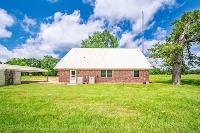 397 Rs County Road 4452, Point, TX 75472 - rear view of property with brick siding, a yard, a detached carport, and central AC