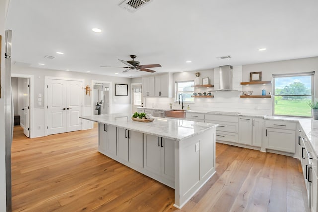397 Rs County Road 4452, Point, TX 75472 - kitchen with wall chimney range hood, a sink, a center island, open shelves, and healthy amount of natural light